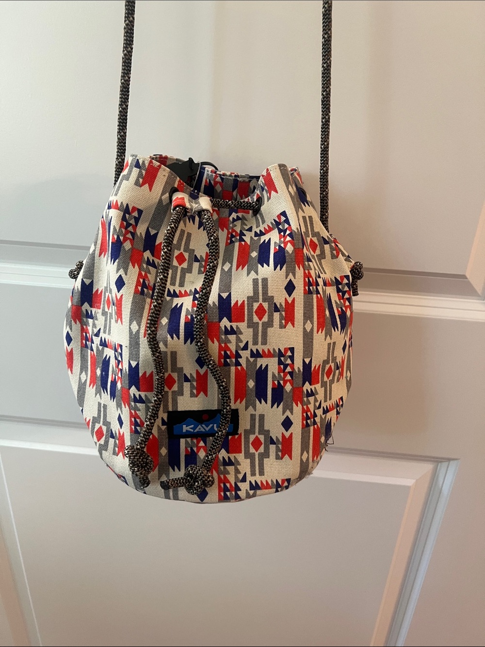 Kavu Cream Crossbody Bucket Bag with Red & Blue Geometric Print